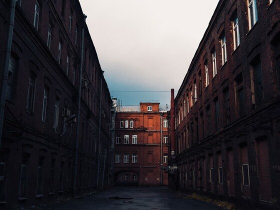 Two warehouse style buildings leading to a dead end of another warehouse building.