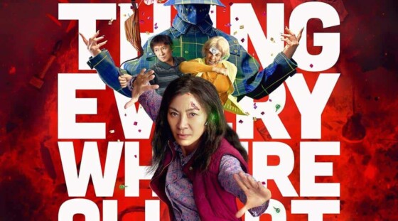 Michelle Yeoh in a kung fu pose in front of characters from Everything, Everywhere, All at Once