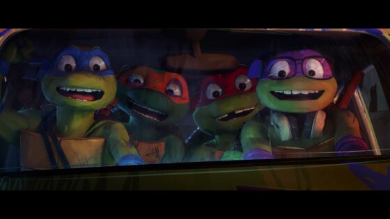 The turtles are driving a van with a look of excitement across their faces.
